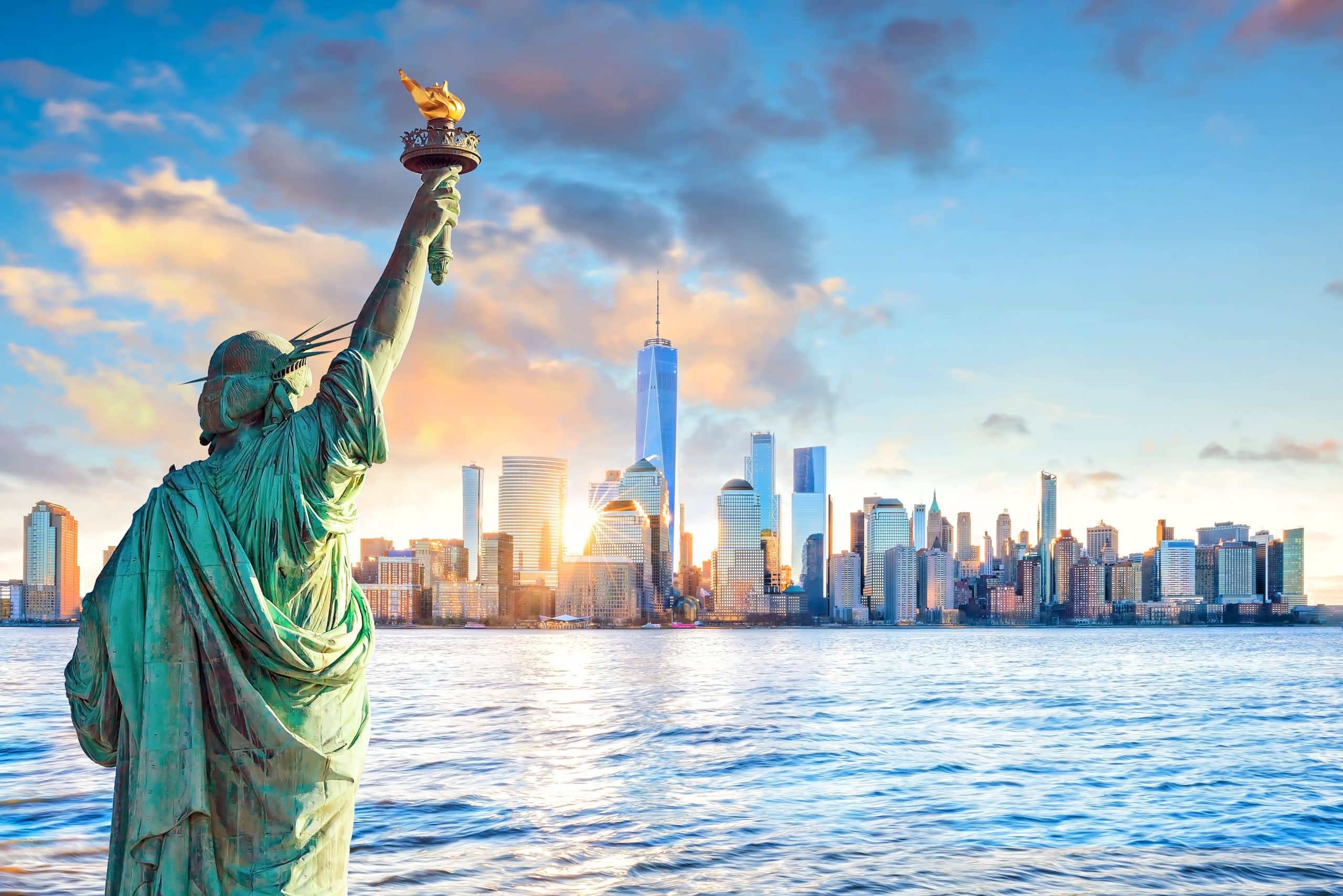 Statue Liberty and  New York city skyline at sunset,  in United States