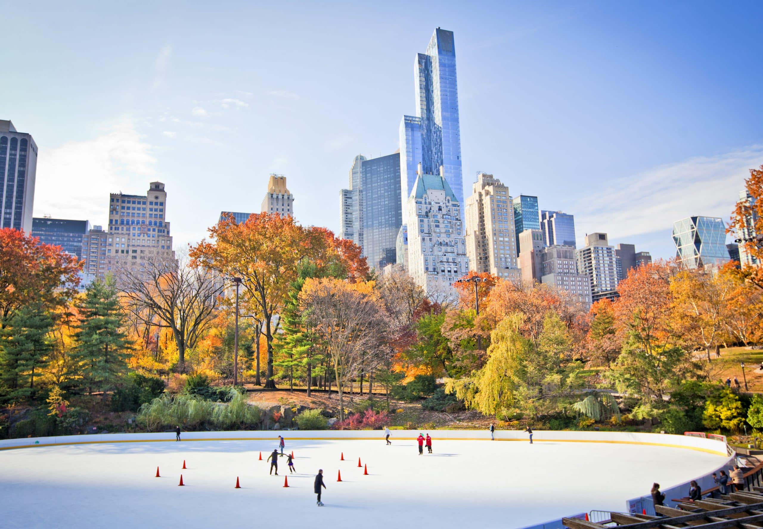 Ice skaters having fun in New York Central Park in fall